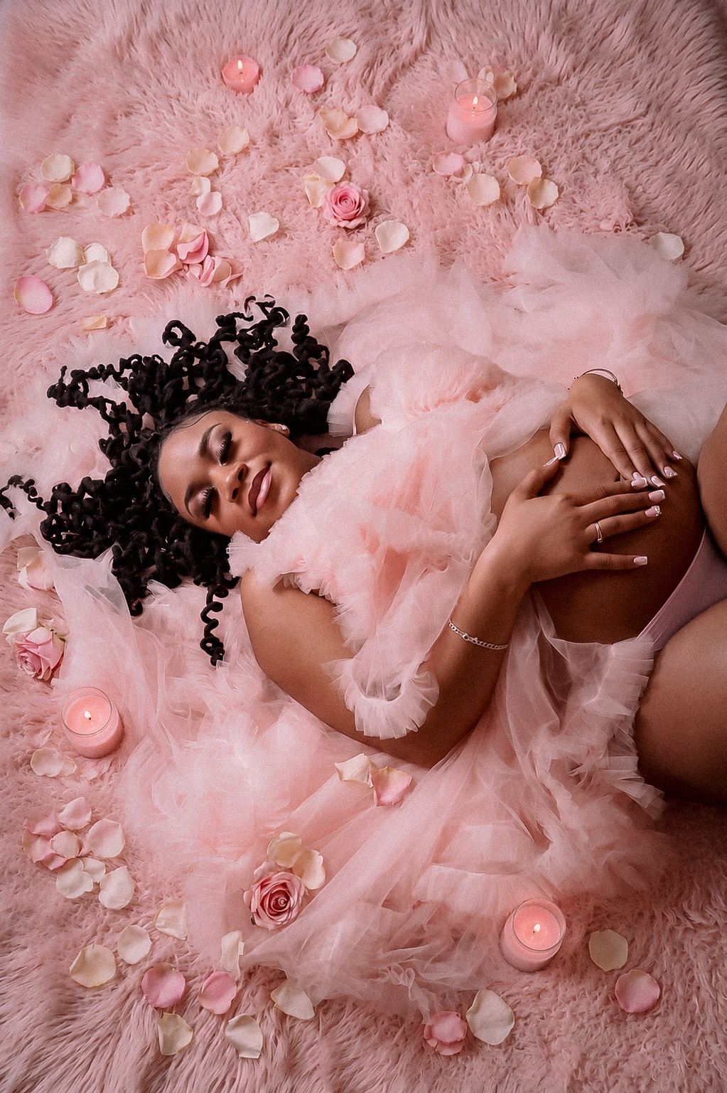 Maternity portrait with candles and florals