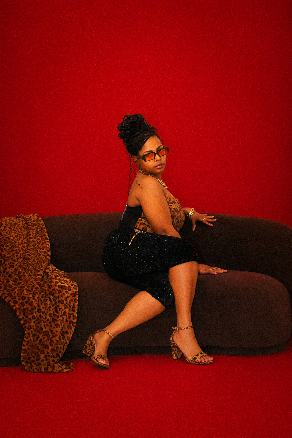 Editorial portrait on red, leopard accents
